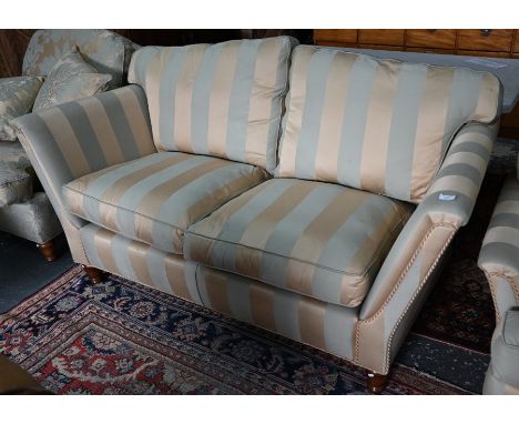 A Duresta two seat sofa upholstered in pale gold/teal stripe (match to armchairs lot 572)