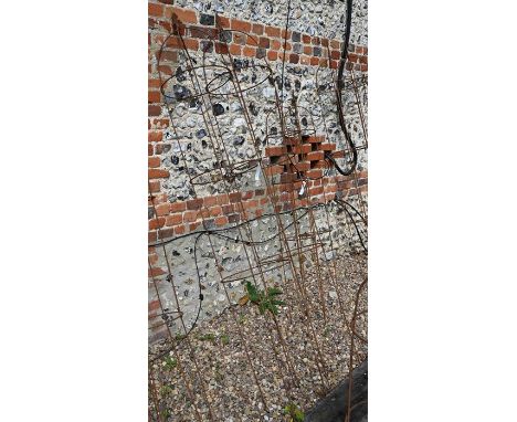 A pair of weathered steel arrow-head garden obelisks, approx. 210 cm high x 37 cm diameter 
