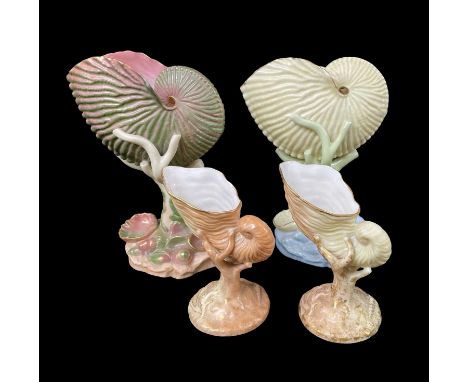 FOUR ROYAL WORCESTER NAUTILUS SHELL VASES, the two larger examples (17cms high) in unusual colourways and numbered 101 to bas