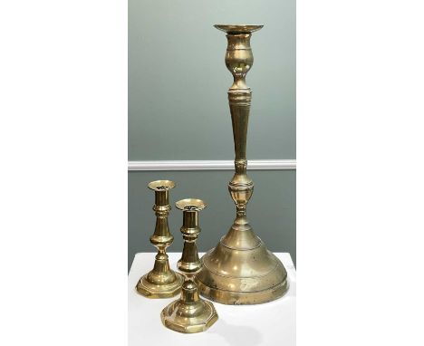 19TH CENTURY OTTOMAN SPUN BRASS CANDLESTICK, with impress mark to rim of sconce, 43cms high x 17cms wide at base together wit