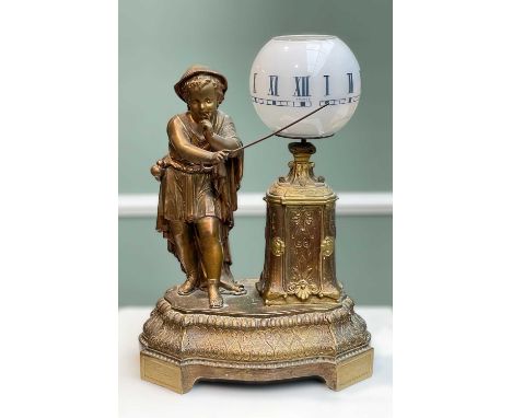 FRENCH NOVELTY LAMP CLOCK, gilt spelter figure of a youth with cane beside opaque glass rotating globe with roman numerals, 3