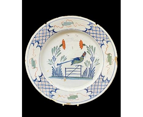 18TH CENTURY ENGLISH DELFT POLYCHROME DISH, probably Bristol c. 1750, naively painted with bird on a gate, within Chinese sty