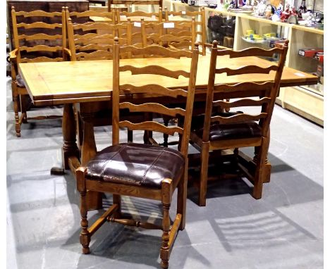 Willis and Gambier golden oak dining table, L: 292 cm (extended), H: 76 cm, and a set of eight (6+2) ladder back chairs. Seat