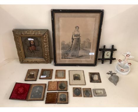 A quantity of iconic and religious artefacts, including a gilt framed painting and tin relief of Jesus, a ceramic model of Je