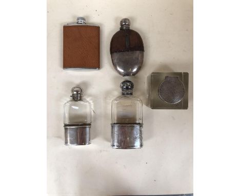 Two sterling silver and glass hip flasks and two white metal and leather mounted hip flasks, and a silver topped inkwell (som