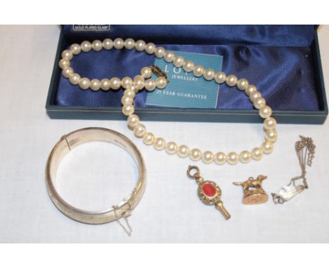 A silver oval bangle, a pocket watch key, dog fob, pearl-effect necklace etc.