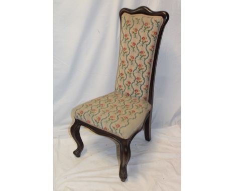 A Victorian mahogany prayer-style chair upholstered in floral tapestry on scroll-shaped legs