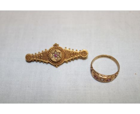 A 15ct gold bar brooch set central ruby and seed pearls and a 15ct gold dress ring set a central diamond flanked by two small