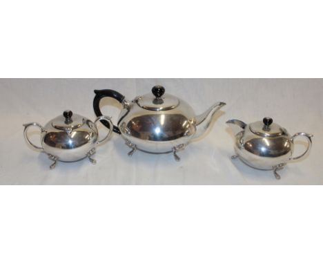 A good quality silver-plated three-piece tea set comprising circular tea pot with ebonised handle, matching two-handle sugar 