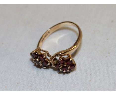 A 9ct gold dress ring set a twin garnet floral cluster (2.9g)