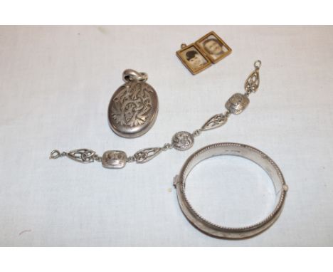 A silver oval bangle with engraved decoration, silver bracelet with Norwegian viking ship decoration, and two various locket 