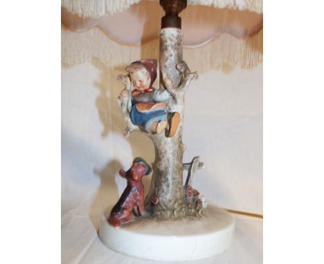 A Goebel china table lamp in the form of a child climbing a tree