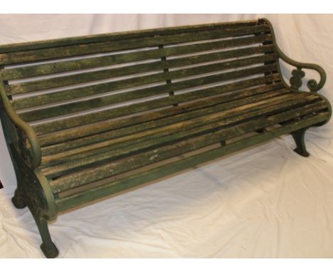 A Victorian garden bench with cast-iron pierced ends and slatted body, 73" long