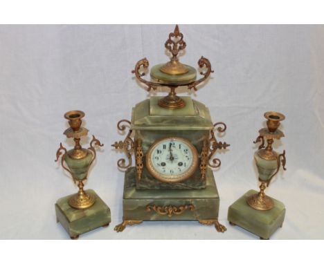 A good quality mantel clock with decorated circular dial in brass mounted onyx case flanked by a pair of matching onyx and br