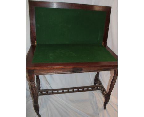 A 19th century walnut rectangular turn-over-top card table with baize lined playing surface on turned legs