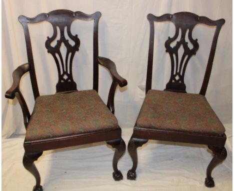 A set of four single and one carver mahogany Chippendale-style dining chairs with pierced vase splat backs and upholstered se