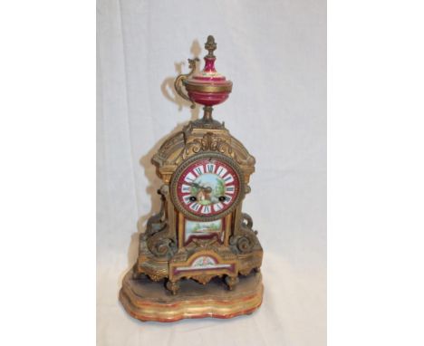 A 19th century Continental gilt spelter mantel clock with porcelain decorated dial and panels on shaped stand, 15½" high (af)