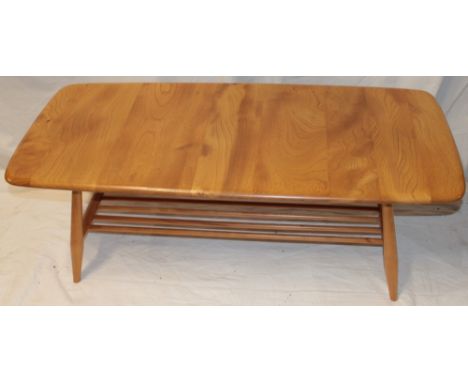 A 1960's/70's Ercol pale elm coffee table with magazine rack on tapered legs, 39" long