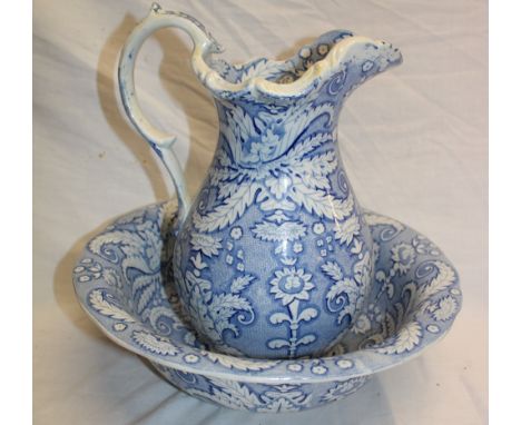 A 19th century Staffordshire pottery baluster-shaped water jug with blue and white floral decoration, 11" high together with 