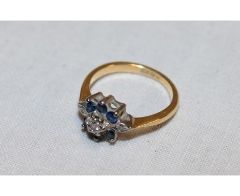 An 18ct gold dress ring set sapphires and diamonds (3.4g)