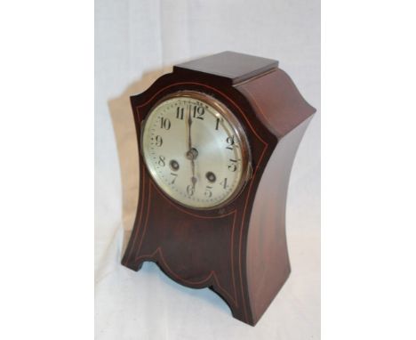 An Art Nouveau-style mantel clock with silvered circular dial in inlaid mahogany case
