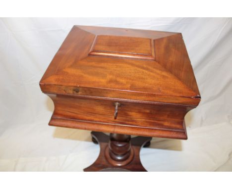 A Victorian mahogany rectangular teapoy with plain fabric lined interior enclosed by a hinged lid on turned column with plate