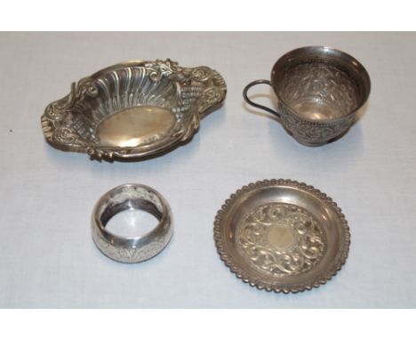 A small silver sweet meat dish with raised and pierced scroll decoration; a silver circular napkin ring and an Indian ornamen