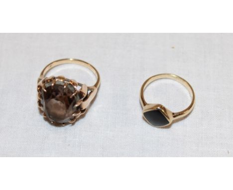 A 9ct gold dress ring set smoky quartz and one other 9ct gold dress ring set a black stone (7.2g) (2)