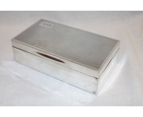 A George V silver rectangular cigarette box with engine turned decoration and engraved initials, London marks 1926, 6¾" long