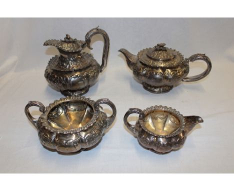 An unusual George IV silver tea and coffee set comprising circular pedestal coffee pot with engraved armorial crest, raised f