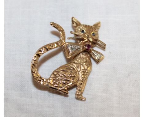 A 9ct gold brooch in the form of a seated cat mounted with sapphires, a ruby and diamond chips (4.4g)