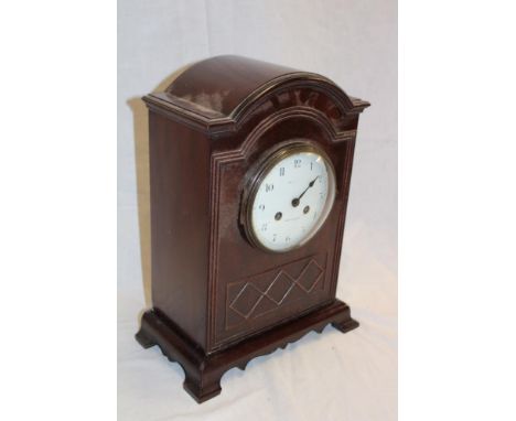 A good quality brass mounted mahogany arched mantel clock by Maple and Co. Paris and London with circular enamelled dial, 14"