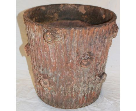 An old terracotta circular planter with rustic decoration in the form of a tree trunk, 25" high