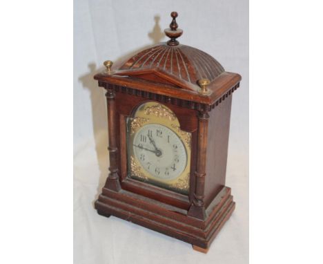 A German mantel clock with silvered and gilt arched dial in walnut and brass mounted case