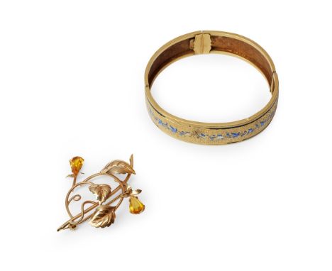 A citrine set brooch  of open scrolling foliate design, set with two pear shaped citrines, stamped 750; together with a hinge