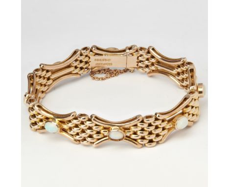 A 9ct gold opal bracelet  composed of fancy brick links, set with oval opal cabochons, to a concealed clasp and safety chain 