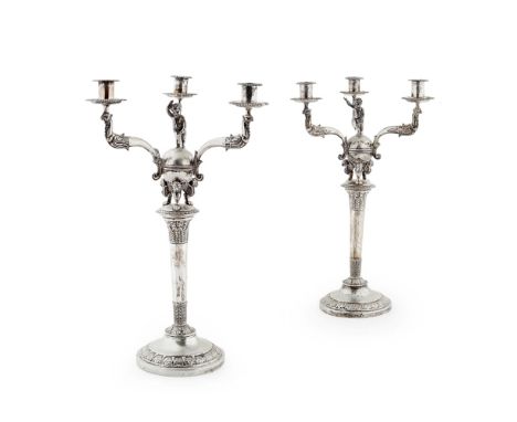 A pair of three light table candelabra  Indistinctly marked, the three scrolling branches with griffins supporting the sconce