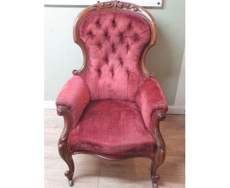 Victorian carved walnut framed button back  nursing chair, upholstered in red on cabriole legs, H111cm 