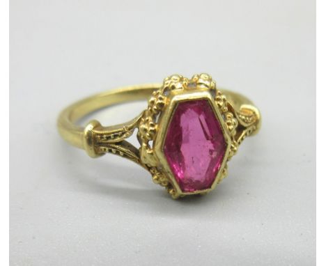 18ct yellow gold ring set with hexagonal cut ruby in rub over mount with ornate border, on plain band, stamped 750, size N1/2