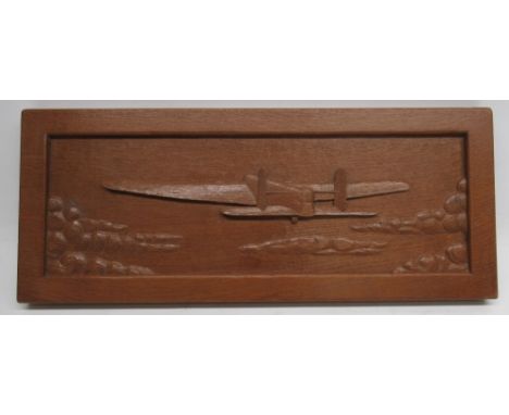 Robert Mouseman Thompson of Kilburn - an adzed oak rectangular panel, relief carved with a Whitley Bomber flying in the sky w