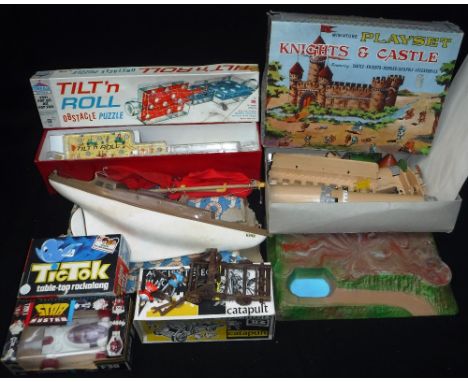 LOUIS MARX & CO: AN EARLY 1960S MINIATURE PLAY SET 'Knights & Castle' (boxed), a 'Tri-ang 'Tilt'n Roll' puzzle (boxed), a Bri