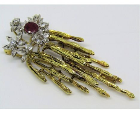 A vintage 14k brooch of stylised foliate design set with diamonds and a ruby, with trombone clasp, 6.6cm long, 16.8g (one dia