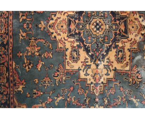 Eastern thick weave carpet decorated with various floral scrolled medallions upon a blue ground, 260 x 180cm