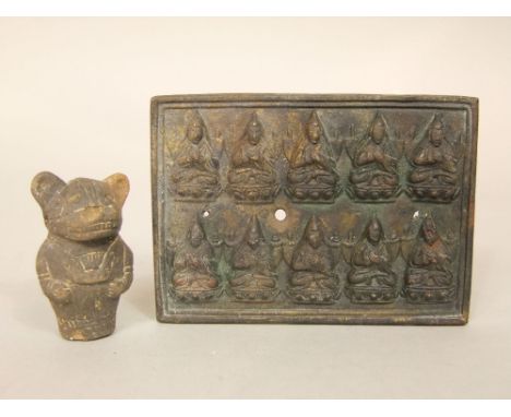 Small cast brass panel detailing two lines of Buddhist figures and an early pre-Columbian terracotta whistle in the form of a