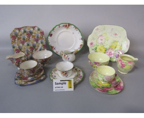 A collection of Crown Staffordshire floral tea wares comprising milk jug, sugar bowl, cake plate, five cups, five saucers and