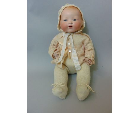 A bisque head baby doll by Armand Marseille with soft trunk and legs and opening and closing eyes, 20 inches long, mould numb