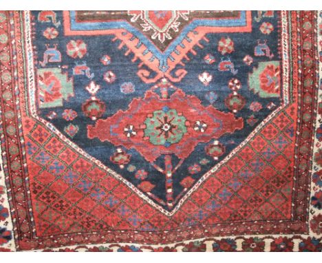 Afghan type floral rug with three central medallions upon a blue ground with red floral fields, 180 x 140cm, together with a 