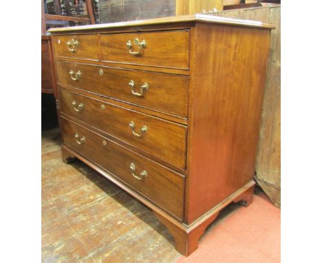 A Georgian mahogany chest of three long and two short drawers, raised on bracket supports with brass swan neck handles and es