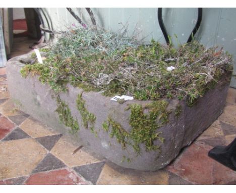 A weathered natural stone trough of rectangular form with rounded front corners, approx 60 cm long x 46 cm wide x 17 cm deep 