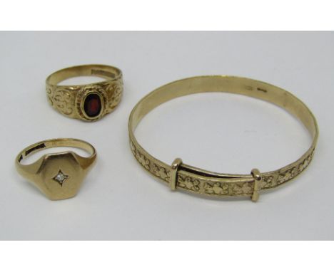Three 9ct items comprising an adjustable bangle with teddy bear decoration, an ornate garnet set ring and a further diamond s